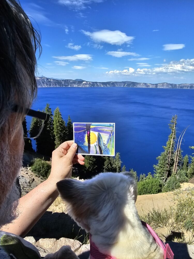 Sadie admiring one of our Soulful cards (Take Up Space) and Crater Lake in Oregon.